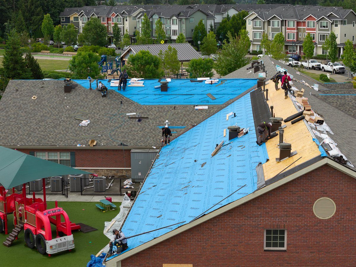 Large commercial roof replacement in progress at Primrose School of Mill Creek, WA with the Liberty crew