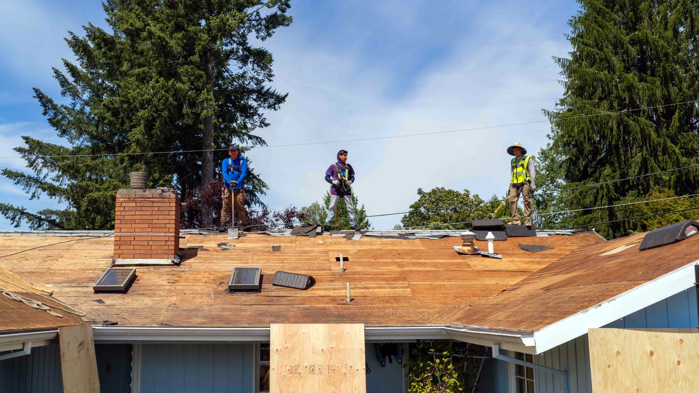 Liberty crew tearing off an old roof on a Portland-area home
