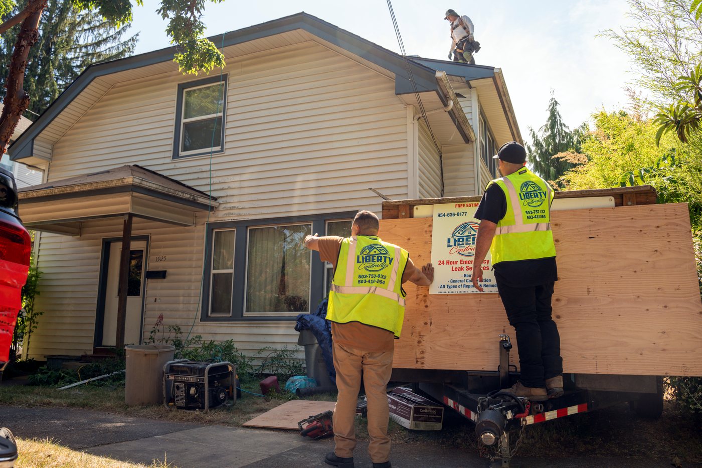 The Liberty General Construction crew in branded vests securing a home in the Pacific Northwest